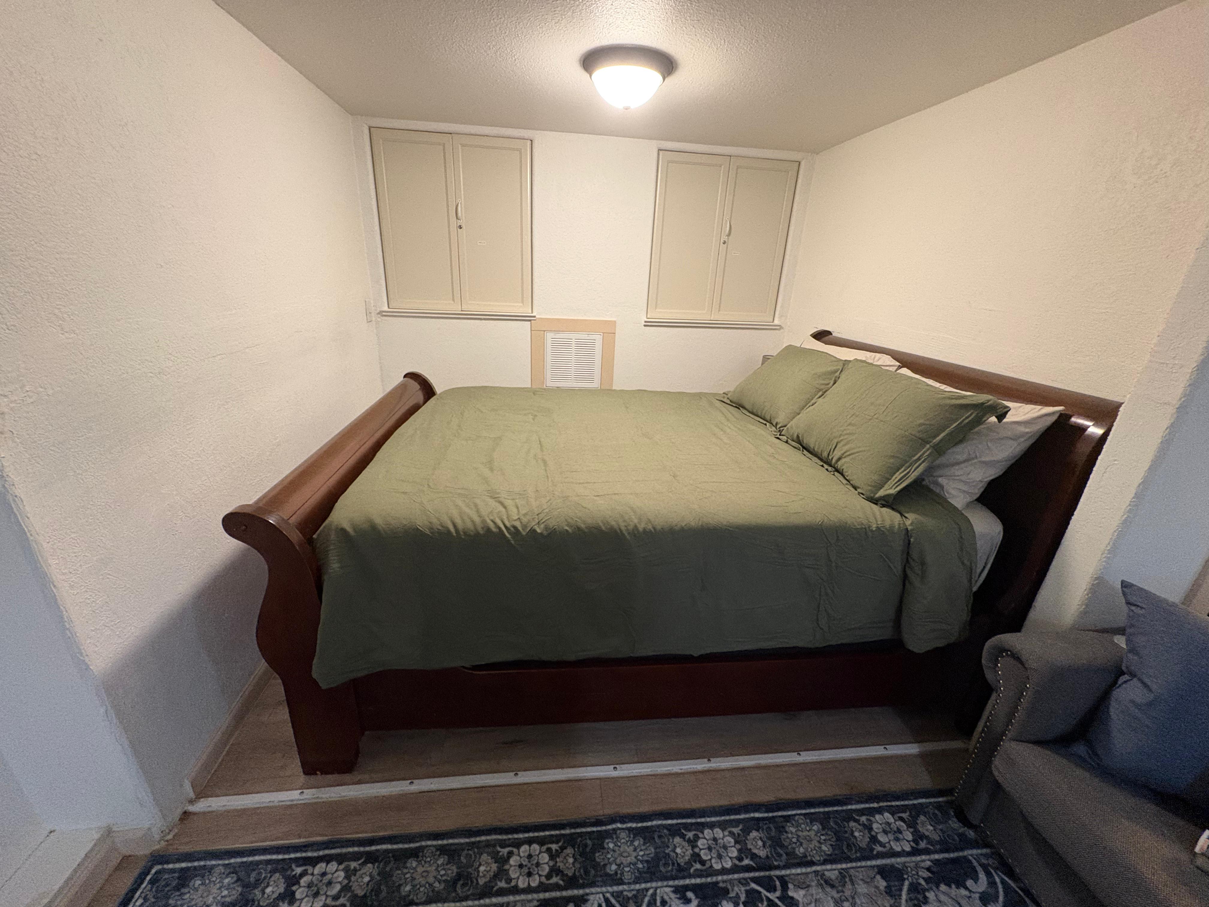 Half Dome Haven sleeping nook with queen sleigh bed and green bedding
