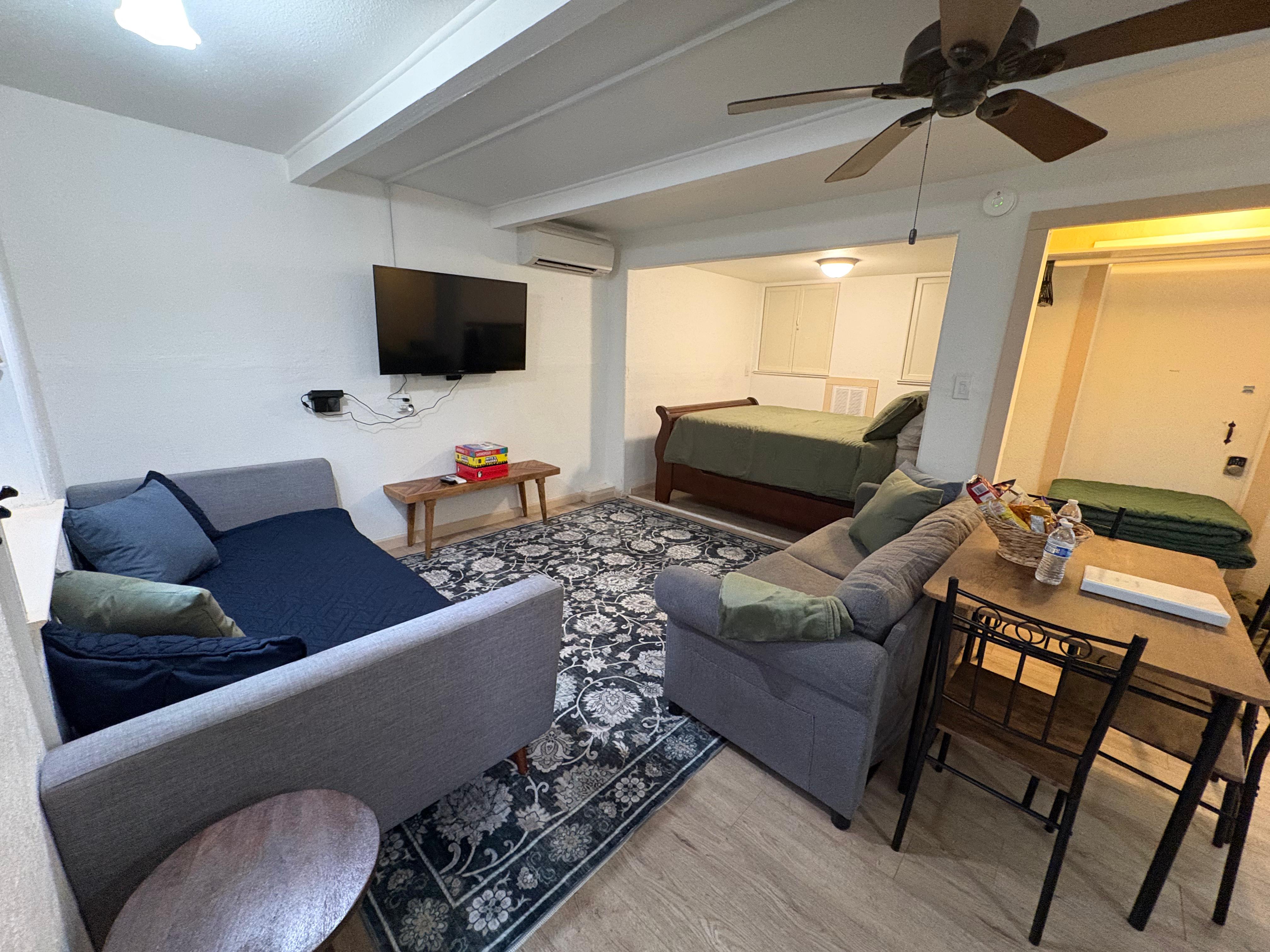 Half Dome Haven open-plan studio showing living area, daybed, and queen bed